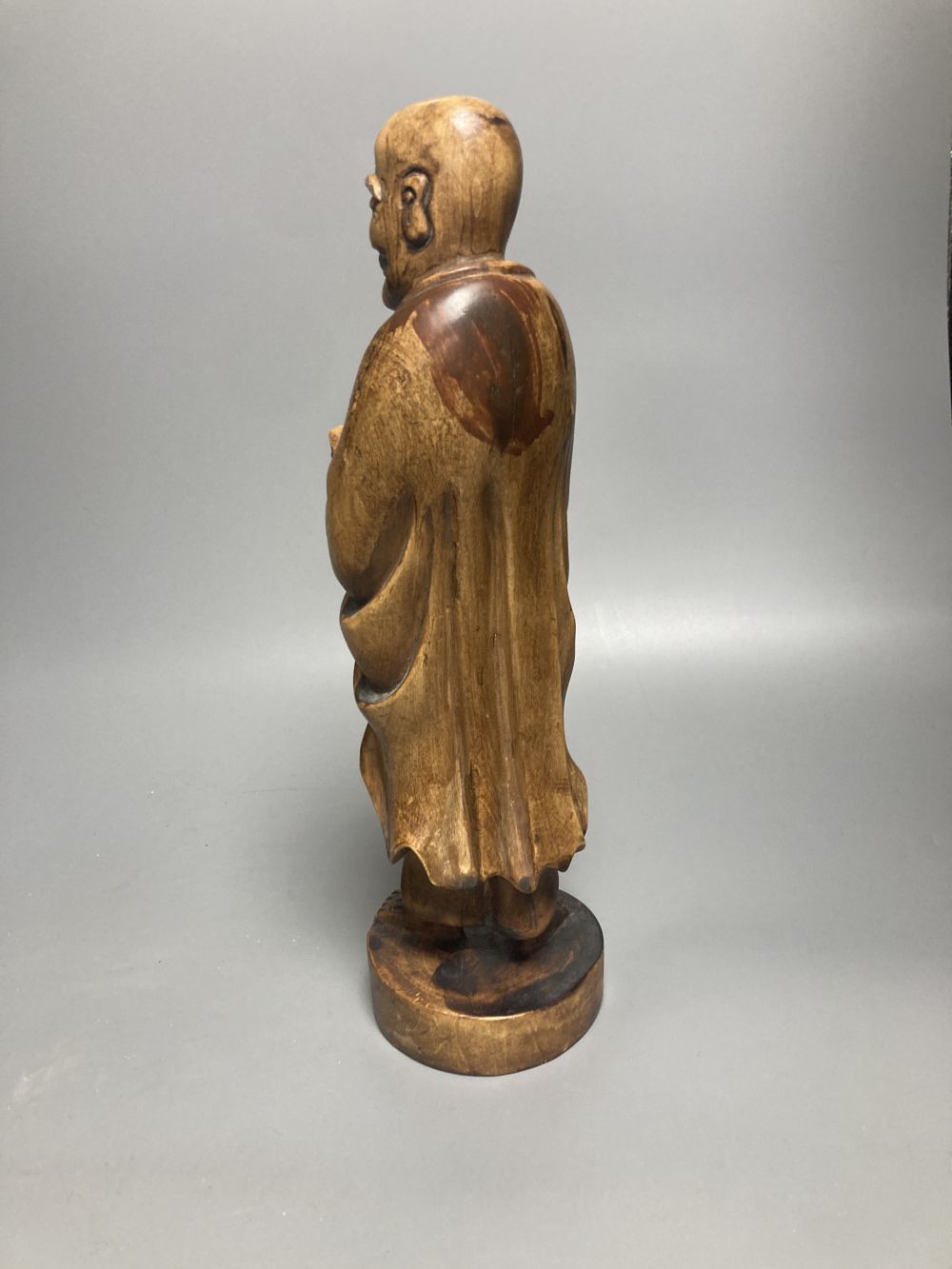 Two Oriental figural wood carvings, tallest 31cm